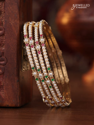 Pearl bangle with kemp stones and pearls in gold finish