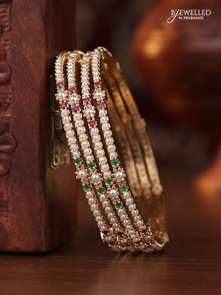 Pearl bangle with kemp stones and pearls in gold finish