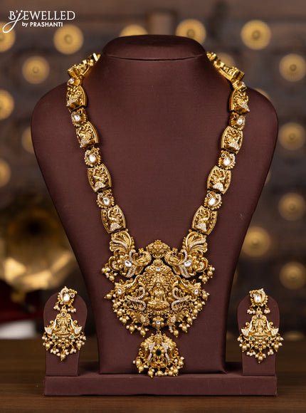 Antique haaram with lakshmi and elephant pendant design in kundan stones and pearl hanging