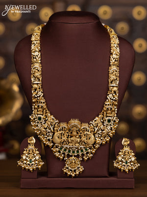 Antique haaram with lakshmi pendant with green and white stones and golden beads hanging
