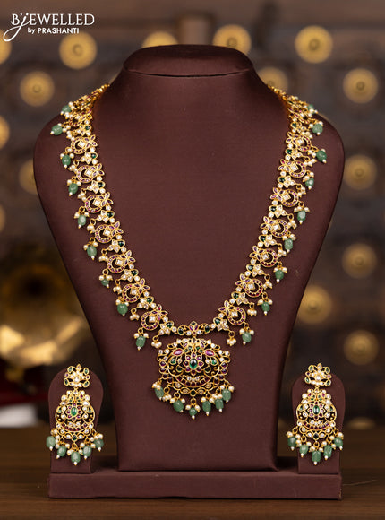 Antique haaram with floral design in multicolor stones and green beads hanging
