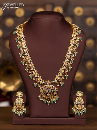 Antique haaram with floral design in multicolor stones and green beads hanging
