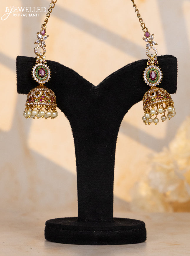 Antique maatal type jhumka in oval design in multicolor stones and pearl hanging