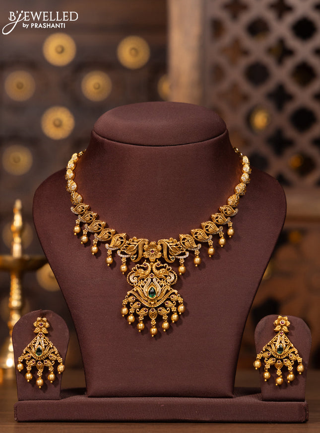 Antique necklace with kemp and cz stones in golden beads hangings