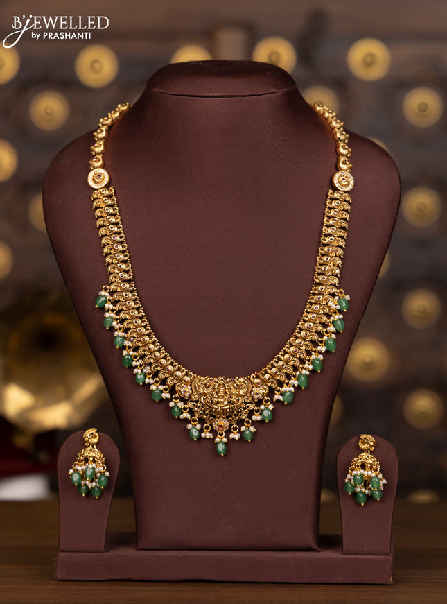 Antique haaram lakshmi design with pink kemp and cz stones in pearl & mint green beads hangings