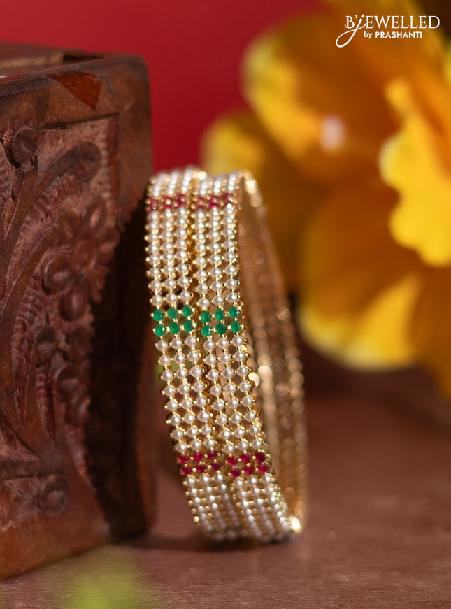 Pearl rajawadi bangles with kemp stones and pearls in gold finish