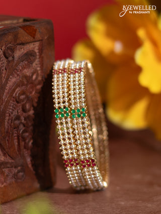 Pearl bangles with kemp stones and pearls in gold finish