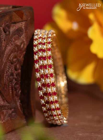 Pearl rajawadi bangles with ruby stones and pearls in gold finish