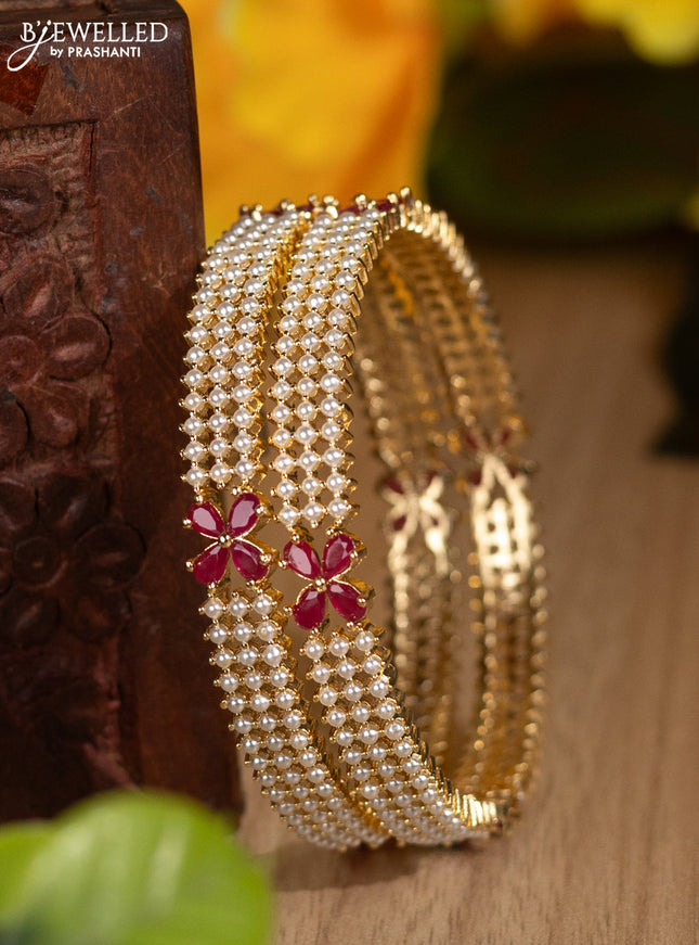 Pearl bangles floral design with ruby stones and pearls in gold finish