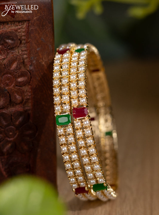 Pearl bangles with kemp stones and pearls in gold finish