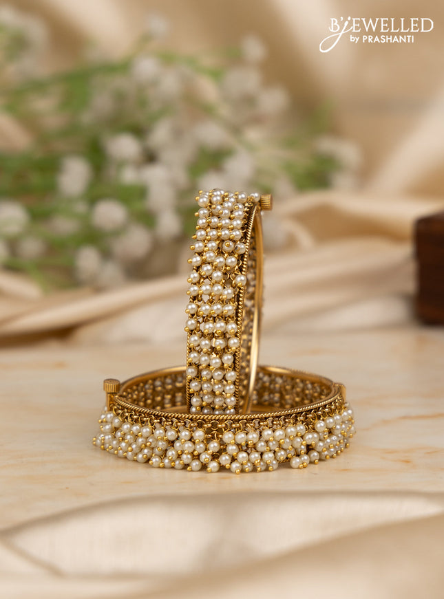 Antique screw type bangles with pearl hangings