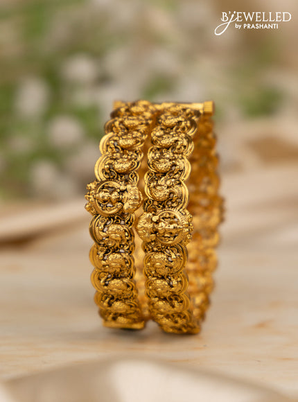 Antique screw type bangles with peacock and lakshmi design