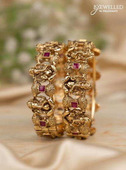 Antique screw type bangles with ganesha design and ruby stones