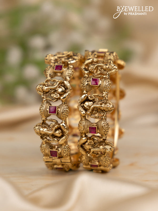 Antique screw type bangles with ganesha design and ruby stones
