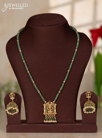Beaded necklace with antique lakshmi pendant in green beads