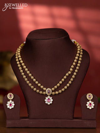 Antique two layer golden beads type necklace with floral pendant in kundan stones