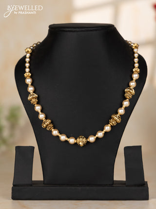 Pearl necklace with antique small round beads embedded in between the pearls
