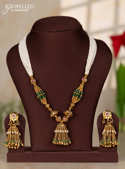 Beaded white multilayer necklace with antique jhumka pendant in red color kemp stones