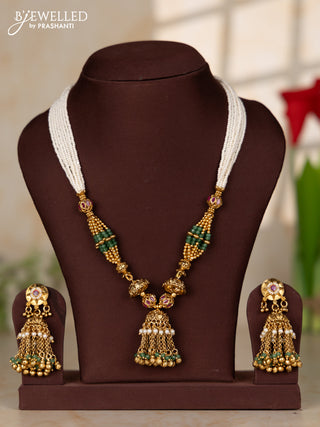 Beaded white multilayer necklace with antique jhumka pendant in red color kemp stones