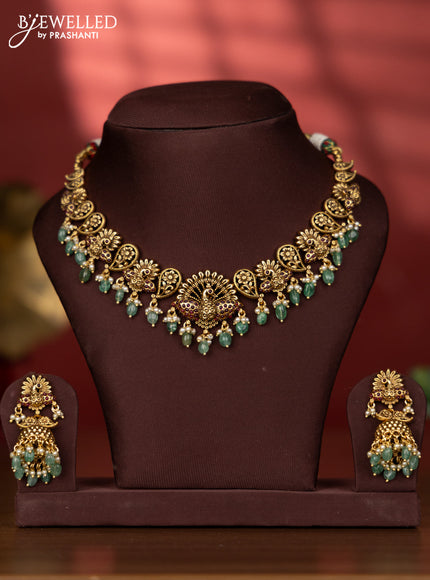 Antique necklace with peacock deisgn in red kemp stones and green beads hanging