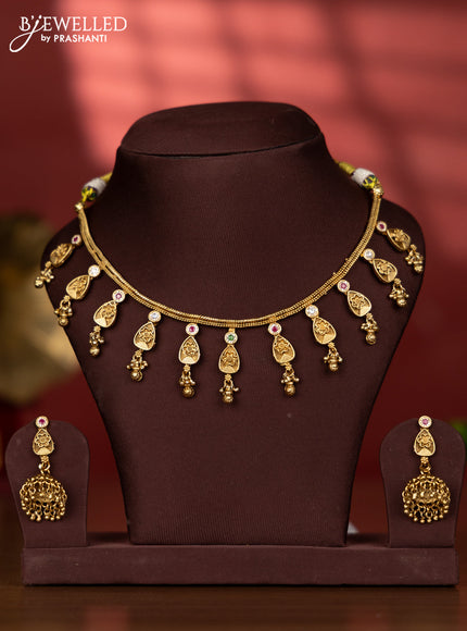 Antique necklace with floral pendant and golden beads hanging