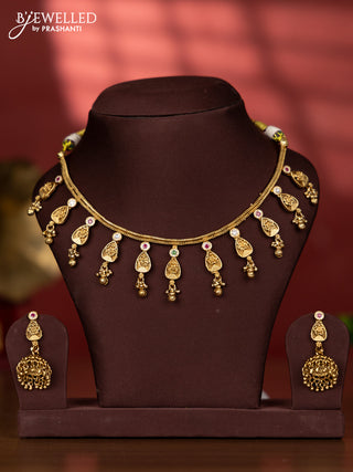 Antique necklace with floral pendant and golden beads hanging