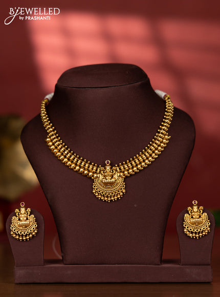 Ring type choker with lakshmi pendant in red kemp stones and golden beads hanging