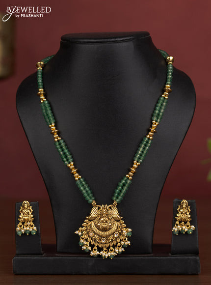 Antique beaded necklace lakshmi pendant with kundan stones and pearl & green beads hanging