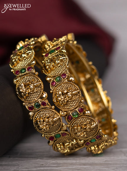 Antique screw type bangle with lakshmi design and kemp stones