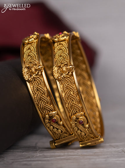 Antique screw type bangle with peacock design and pink kemp stones
