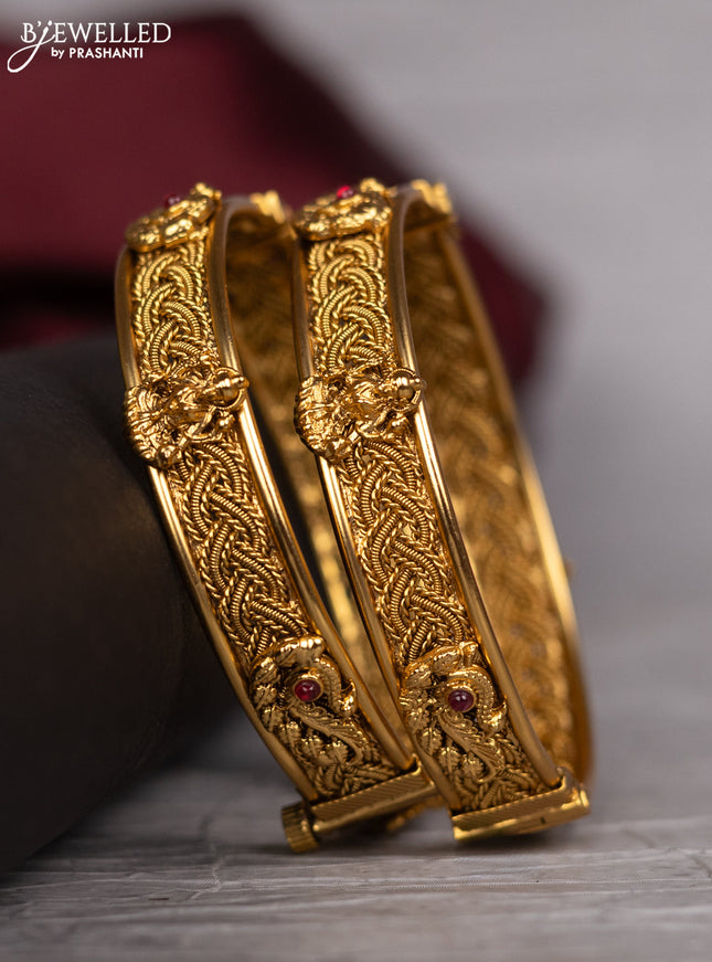 Antique screw type bangle with peacock design and pink kemp stones
