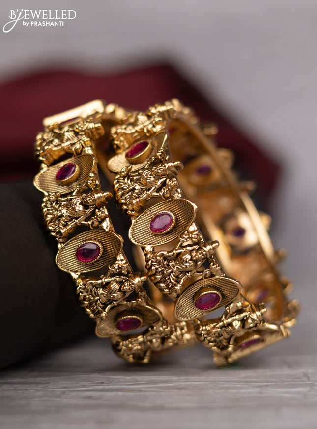Antique screw type bangle with lakshmi design and pink kemp stones
