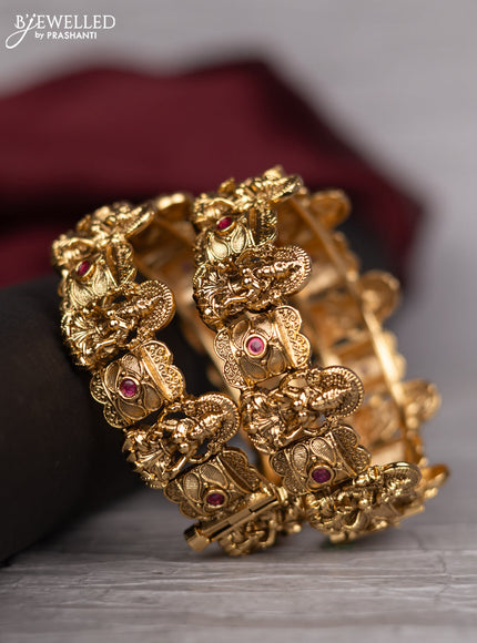 Antique screw type bangle with lakshmi design and pink kemp stones