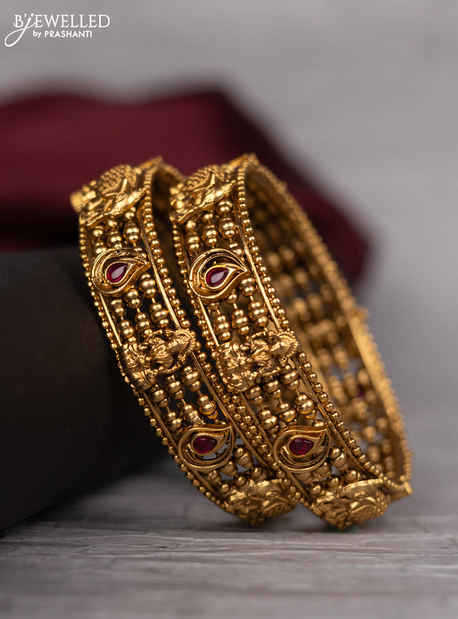 Antique screw type bangle with elephant design and pink kemp stones