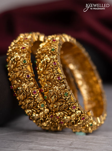 Antique screw type bangles with lakshmi design and kemp stones