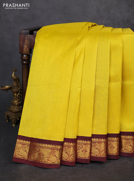 Silk cotton saree yellow and deep maroon with plain body and zari woven korvai border