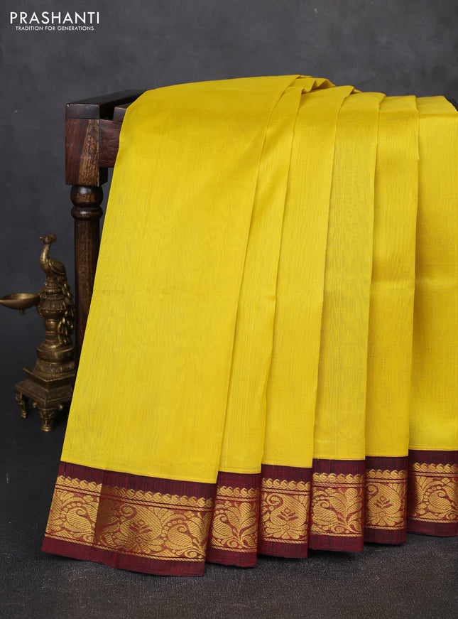 Silk cotton saree yellow and deep maroon with plain body and zari woven korvai border