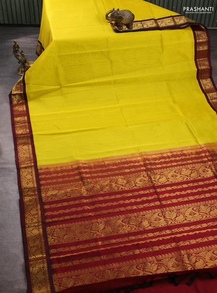 Silk cotton saree yellow and deep maroon with plain body and zari woven korvai border