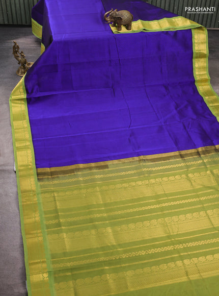 Silk cotton saree violet and light green with plain body and zari woven korvai border