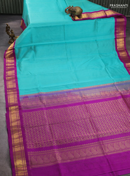 Silk cotton saree teal blue and purple with plain body and zari woven korvai border