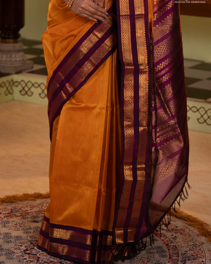 Silk cotton saree mustard yellow and purple with plain body and rettapet zari woven korvai border