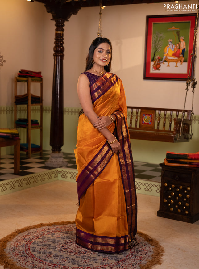 Silk cotton saree mustard yellow and purple with plain body and rettapet zari woven korvai border