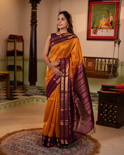 Silk cotton saree mustard yellow and purple with plain body and rettapet zari woven korvai border
