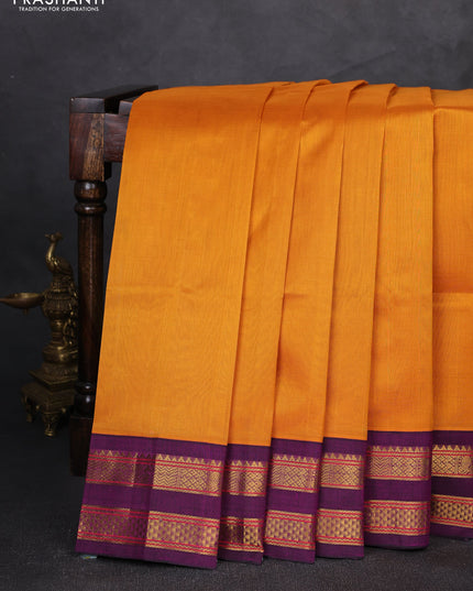 Silk cotton saree mustard yellow and purple with plain body and rettapet zari woven korvai border
