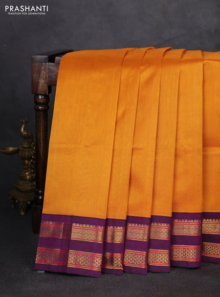 Silk cotton saree mustard yellow and purple with plain body and rettapet zari woven korvai border