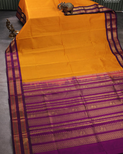 Silk cotton saree mustard yellow and purple with plain body and rettapet zari woven korvai border