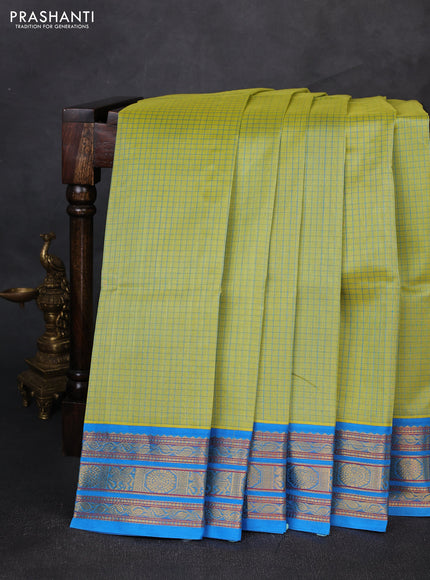 Silk cotton saree pista green and cs blue with allover small checked pattern and temple zari woven korvai border