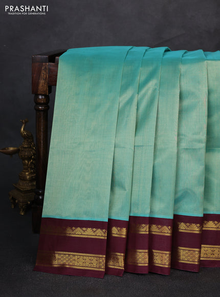 Silk cotton saree teal green and coffee brown with plain body and rettapet zari woven korvai border