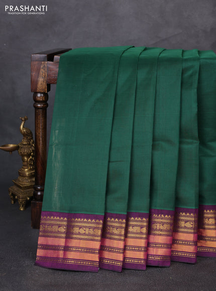 Silk cotton saree bottle green and purple with plain body and temple zari woven korvai border