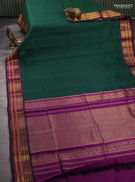 Silk cotton saree bottle green and purple with plain body and temple zari woven korvai border